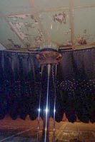 Underneath the craft, whilst on jacks. Again a rare experience, this shows one of the seven hydraulic jack rams raised. This is at the bow of the craft. A few things to note here - <br><br>The rubber pad onto which the jack ram (rusty) is placed. This is one of the seven landing pads underneath the SRN4 - on landing it didnt sit on the skirt or even have a metal-to-ground contact. Instead it was placed down on these giant rubber biscuits, engineered to be the strongest points of the craft's structure.<br><br>The buoyancy tanks, seperated by a rusty coloured criss-cross grid and riveted together. These insulated tanks ensured the ability of the hovercraft to float, no matter how much feasible damage.<br><br>The fingers. Notice the skirt is not a tube all the way to its base, especially at the front, but is indeed made up of ripples of cone-shaped fabric toward the bottom. These allow better ride quality, and less wear on the main bag. The skirt is at its biggest at the bow, giving the craft its wave-riding characteristic nose-high attitude in flight.